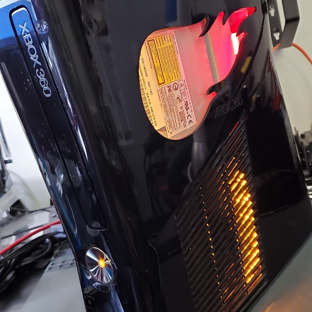 Custom modded RGH Xbox 360 with window and LED designs.